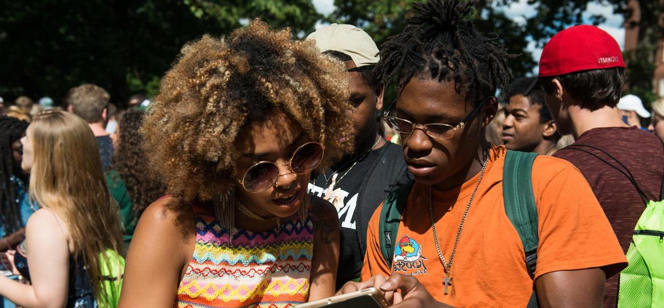 Two students look at a phone together